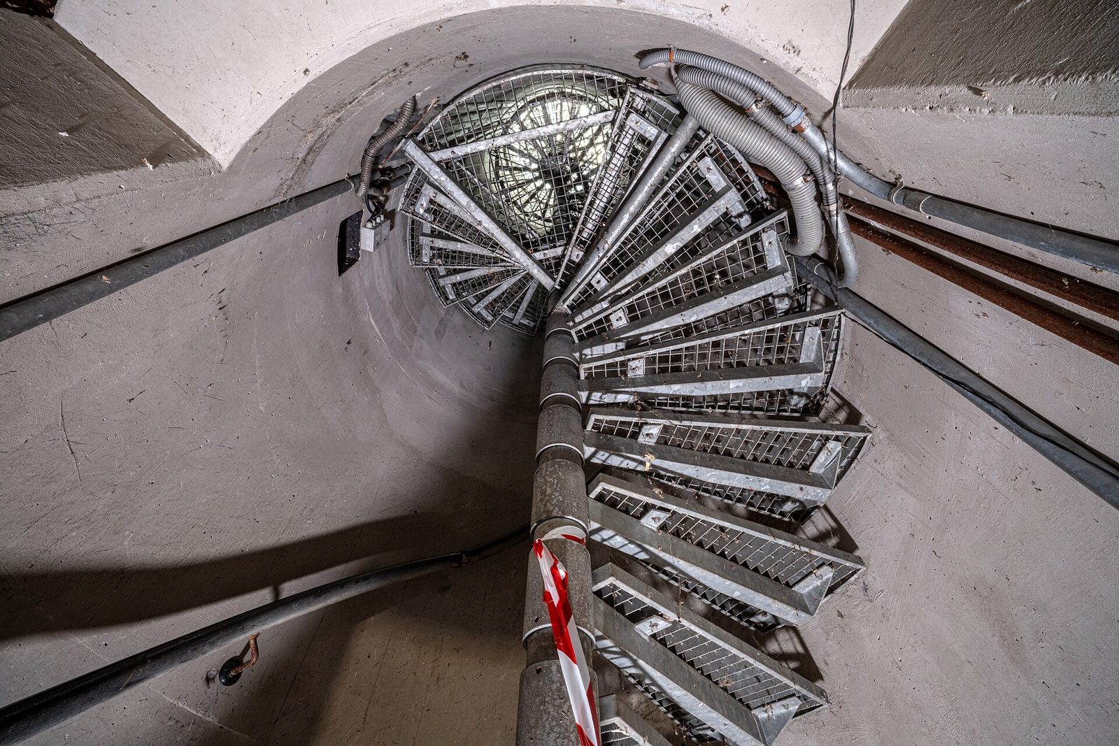 Spiral steel stair inside a concrete tower