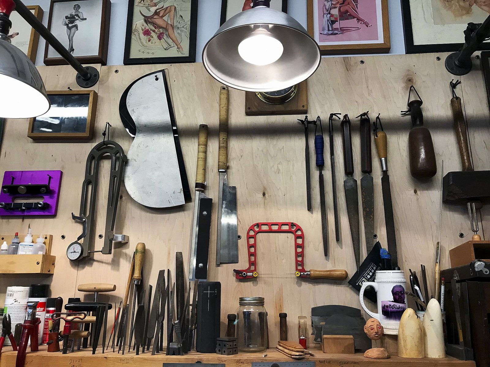 An artisan's hand tools laid out on a bench